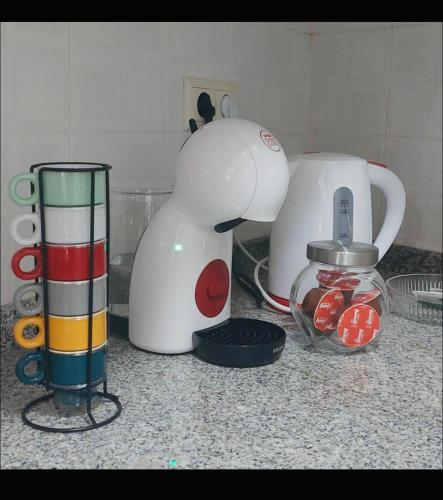 a counter top with a blender and a tea kettle at Casa da Tia Binda - refúgio no centro histórico in Monção