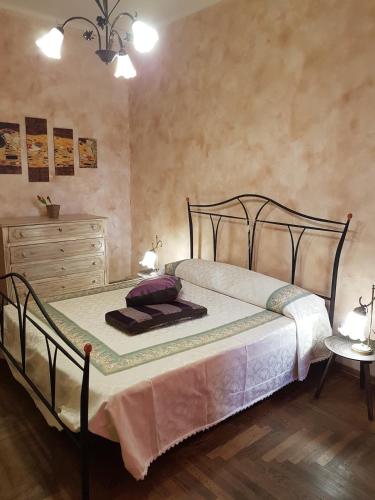 a bedroom with a bed and a dresser in a room at Casa Marisa in Albenga