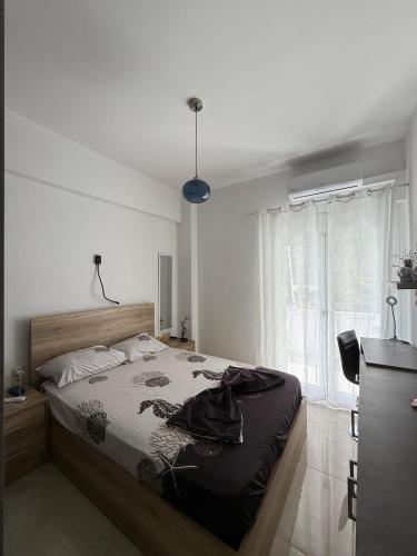 a bedroom with a bed in a room with a window at Spacious & Fully Equipped 2-Bedroom Apartment in Heraklion in Heraklio
