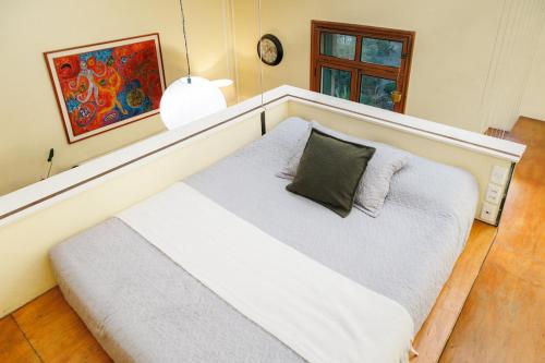 a bedroom with a large white bed with a pillow at Historic Loft Overlooking Plaza de Armas in Santiago