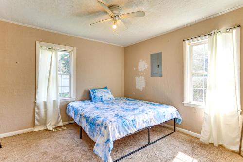 a bedroom with a bed and two windows at 2 Mi to Fort Sill Quiet Family Retreat with Yard in Lawton
