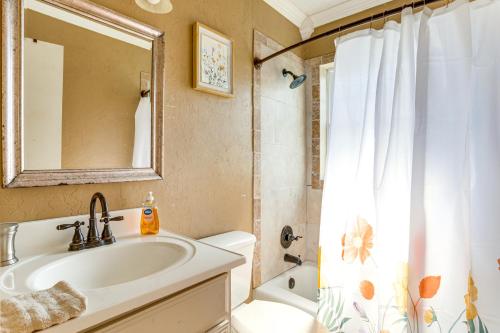 a bathroom with a sink and a toilet and a mirror at 2 Mi to Fort Sill Quiet Family Retreat with Yard in Lawton