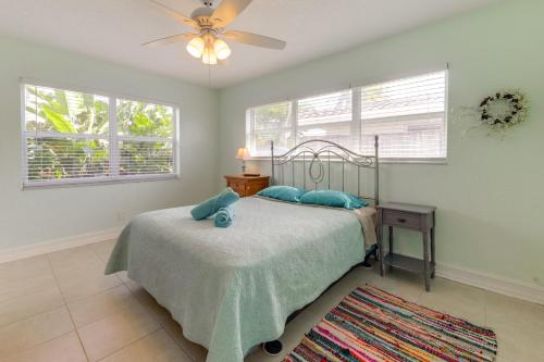 a bedroom with a bed and a ceiling fan at Walk to The Cove! Central Deerfield Beach Home in The Cove