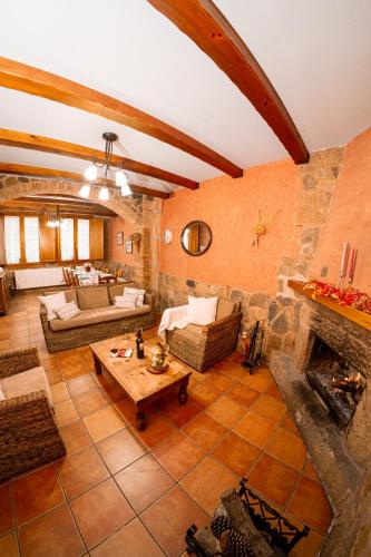 a large living room with a stone wall at Casa Rural La Milagrosa in San Martín de Moncayo