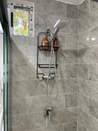 a shower with a shower head in a bathroom at Consulado Americano Santa Catarina a 3 min in Monterrey