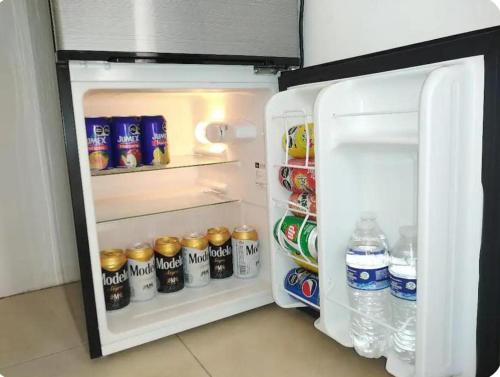 an open refrigerator filled with drinks and drinks at Alberca-Privacidad-Confort in Mérida