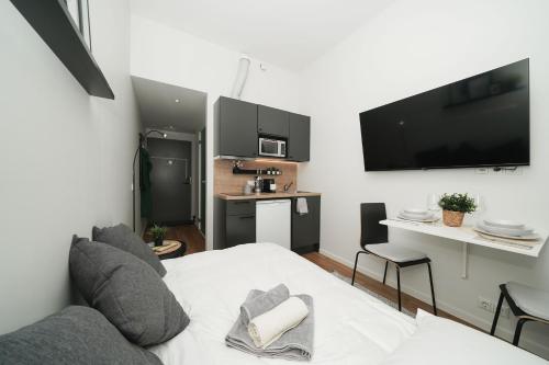 a living room with a couch and a tv at Stylish smart studio in Tallinn