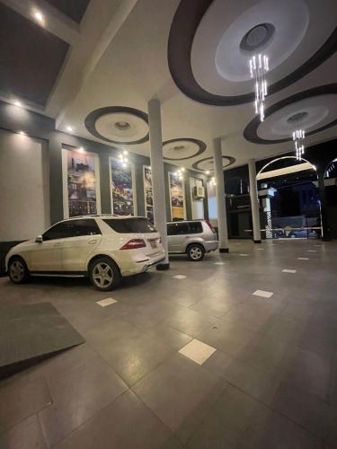 two cars are parked in a parking lot at The Ivory Hotel in Nairobi
