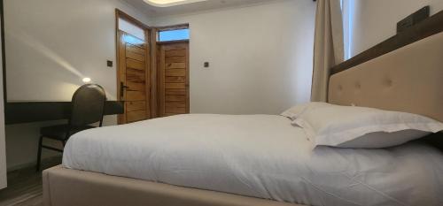 Ένα ή περισσότερα κρεβάτια σε δωμάτιο στο The Beleza Suites