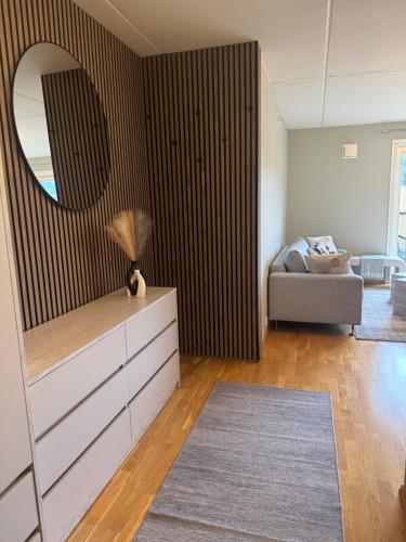 a living room with a dresser and a mirror at Verven 10 in Stavanger