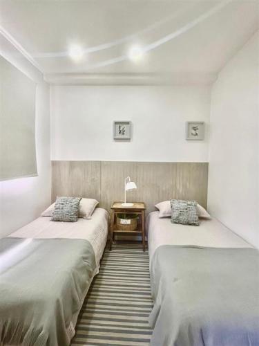 a room with two beds and a table in it at Casa Nidos in Santiago
