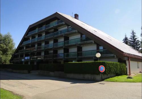 a large building with a sign in front of it at Studio cosy à Métabief in Métabief