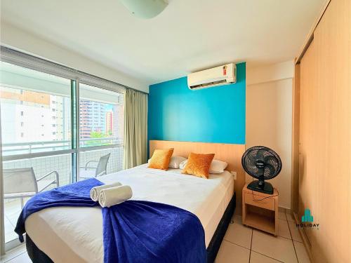 a bedroom with a bed and a window with a fan at Beach Class by Holiday Stays in Fortaleza