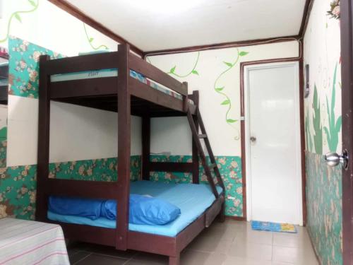 a bedroom with two bunk beds in a room at mama hostel El nido in El Nido
