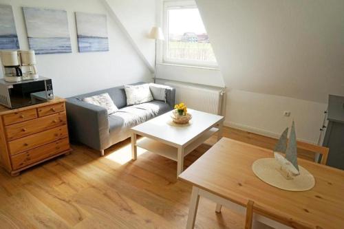 a living room with a couch and a table at Ferienwohnung-Memmert in Baltrum
