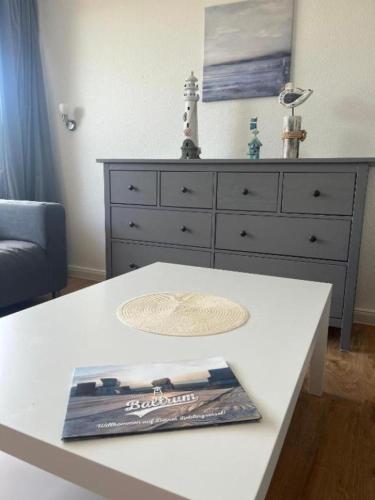 a white table with a dresser in a living room at Ferienwohnung-Helgoland in Baltrum