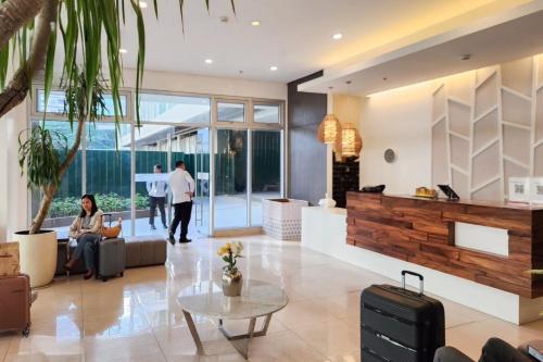 a lobby with a person sitting on a couch at Lovely CondoStay Cebu T2-25 in Cebu City