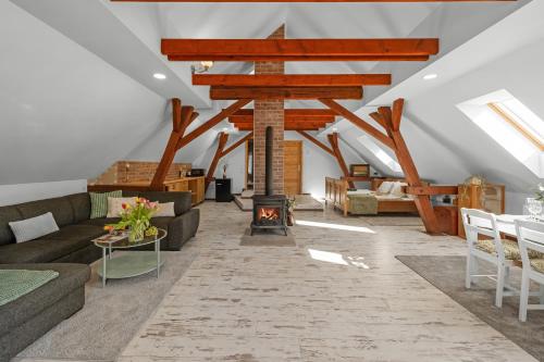 a living room with a couch and a fireplace at Statek Luigi in Tuchlovice