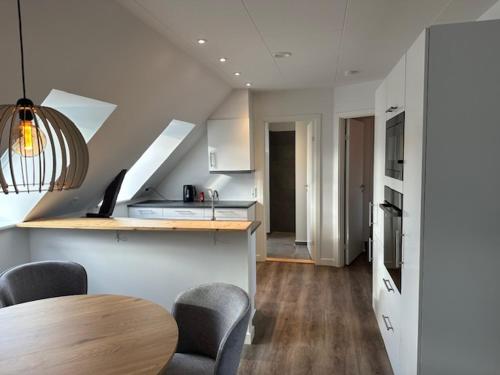 a kitchen with a table and chairs in a room at 11F 2 TV Højbanetorvet in Vejle