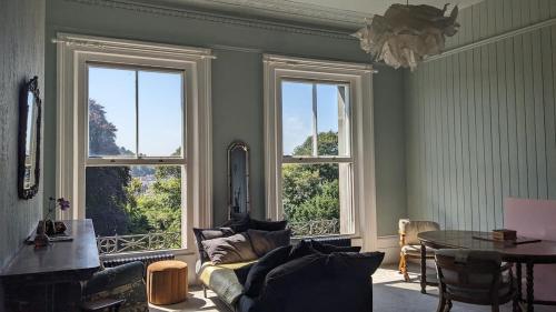 a living room with three windows and a couch at Luxury 1 bed apartment by Dover Castle spacious can sleep 4 in Dover
