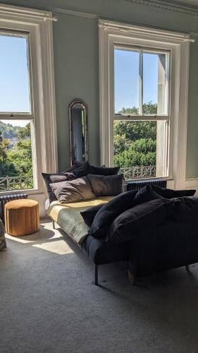 a bedroom with a bed and a mirror and windows at Luxury 1 bed apartment by Dover Castle spacious can sleep 4 in Dover