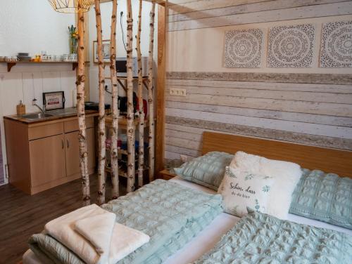 a bedroom with a bed and a wooden wall at Traumfänger in Heltersberg