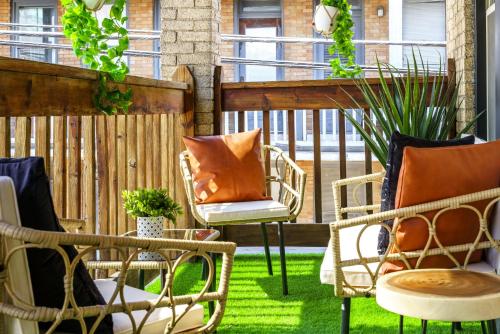 a patio with chairs and a fence at Prime Location Top Rated Clean Parking Free! in Columbus