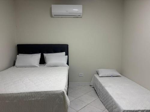 Ένα ή περισσότερα κρεβάτια σε δωμάτιο στο Casa Praça 16 - Porto de Galinhas AFT