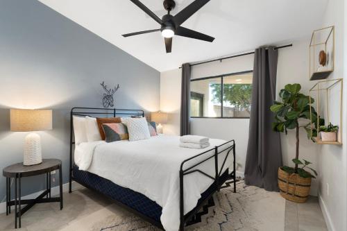 a bedroom with a bed and a ceiling fan at Closest Walk to Old Town, Entertainment District in Scottsdale