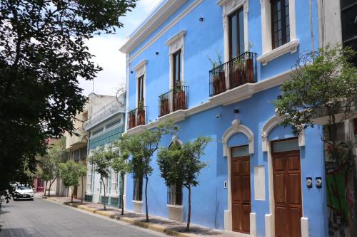 a blue building on the side of a street at Calle y Número, López Cotilla in Guadalajara