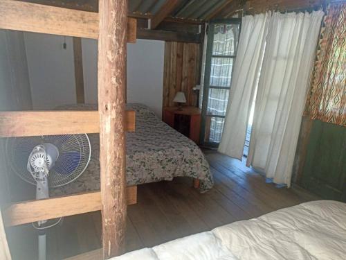 a bedroom with a bunk bed with a fan at Pukará Reservas con depósito in Barra del Chuy