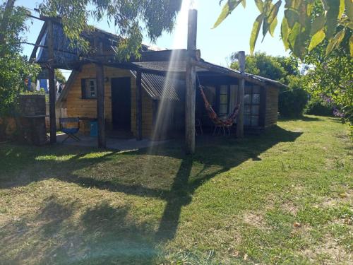 a house with a sprinkler in front of it at Pukará Reservas con depósito in Barra del Chuy