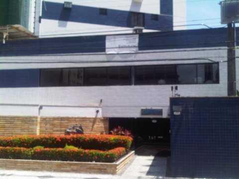 a train is parked in front of a building at Quarto Individual e Privativo - Apt moderno compartilhado com o Hoster - Boa Viagem in Recife