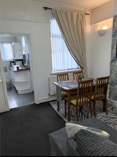 a kitchen and dining room with a table and chairs at Kettering Rooms 4 nights & longer City Vacations Kettering free WiFi for ' Short & Long stays ' Shared bathroom & Shared Kitchen Double room Deals on longer regular stays in Kettering