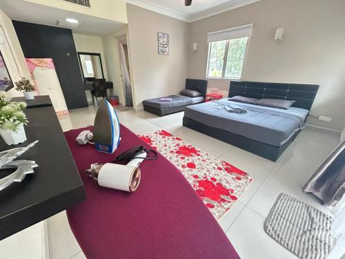 a living room with a bed and a red rug at Tiara Desaru seaview homestay-poolbeachview in Bandar Penawar