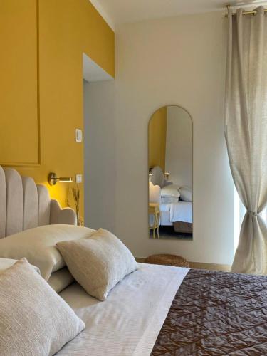 a bedroom with a large bed and a mirror at La Trita Dimore di Charme in Bussi sul Tirino