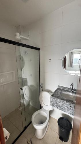 a bathroom with a toilet and a sink and a shower at GRAN PARADA HOTEL in Castanhal
