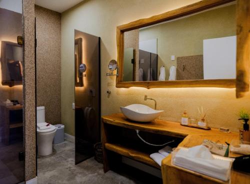a bathroom with a sink and a mirror at Dolphin Hotel in Fernando de Noronha