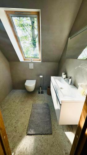 a bathroom with a sink and a skylight at Jaani Mardi Puhkemaja in Sooaluse