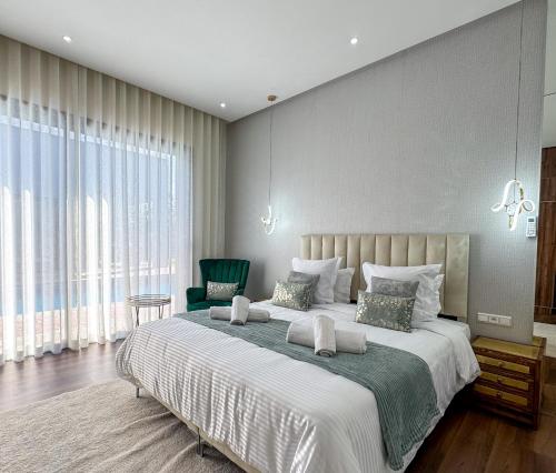 a bedroom with a large bed with a large window at Villa Ramona in Marrakech