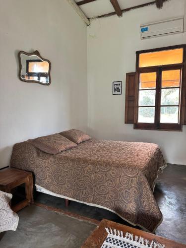 a bedroom with a bed and a mirror on the wall at Casona Las Toscas in Miramar