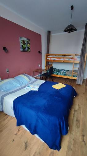 a bedroom with a large bed and two bunk beds at Chambre chez l'habitante "Bambou" in Derval