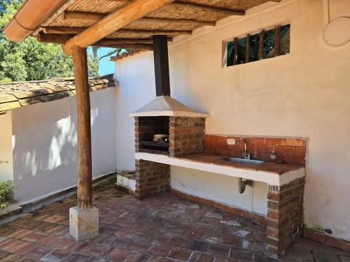 an outdoor kitchen with a brick oven on a patio at Aires de Encanto in Curití