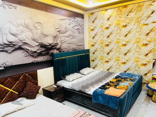 a bedroom with two beds and a painting of a bear at Ram Bhawan HomeStay in Vrindāvan