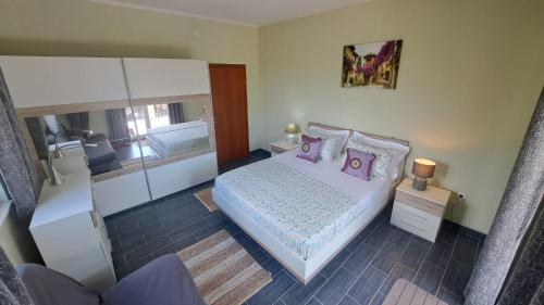 a bedroom with a bed with purple pillows at Villa Aberdeen in Tivat