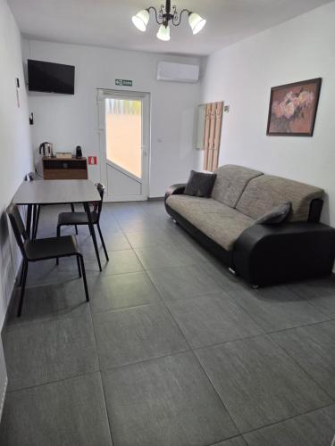 a living room with a couch and a table at Parnica Home 3 in Dudeştii Noi
