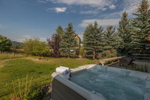 a hot tub in a backyard with a yard at Southfork Retreat in Big Sky