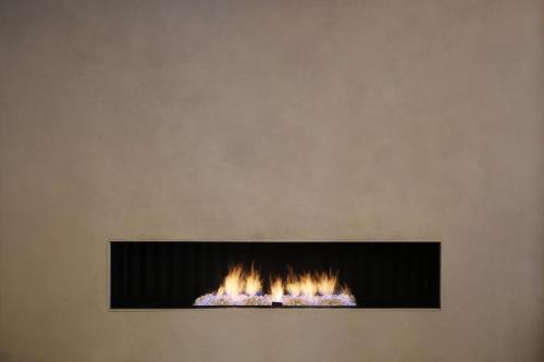 a fireplace on the wall with flames in it at Casa Elliot Hotel in Barcelona