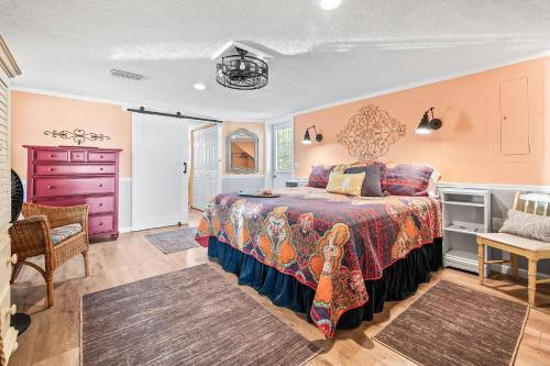 a bedroom with a large bed and a purple dresser at The Sand Euro - 4BR, 3Full & 1Half BA in Historic Summer Haven near beaches and Matanzas Inlet in Summer Haven