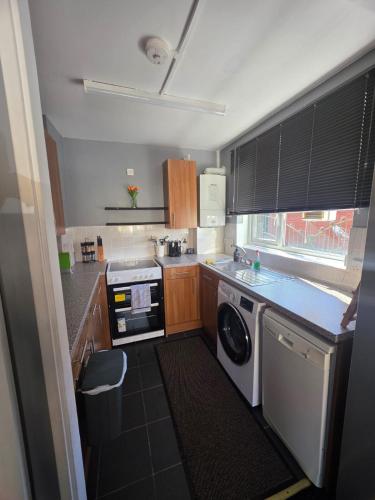 a small kitchen with a washer and dryer at A home in the city in London